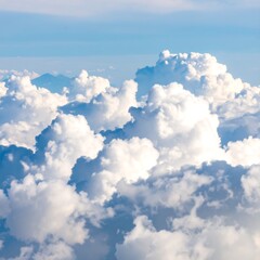 High-altitude view of fluffy white clouds against a clear blue sky