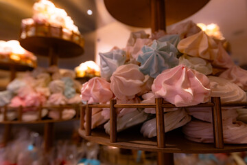 Colorful meringue cookies on a dessert stand.