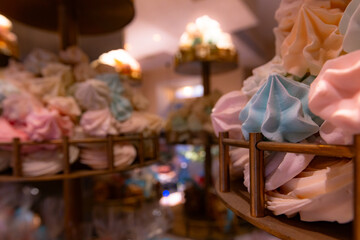 Colorful meringue cookies on a dessert stand.