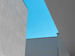 Minimalist view of modern architecture with geometric shapes of white concrete buildings against a