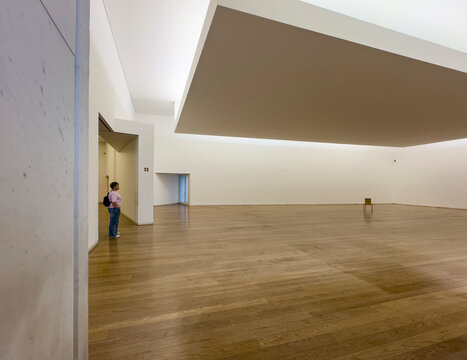 Spacious empty hall with wooden floor and striking ceiling design in the Serralves Museum of