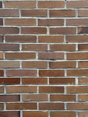 Red brick wall texture with visible rough surface and rustic details, perfect for backgrounds or architectural design.