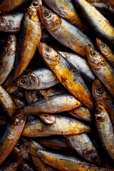 Obraz premium Small fish glisten in the soft morning light as they are piled high at a bustling market. The air is filled with the scent of the sea as vendors prepare for the day’s trade