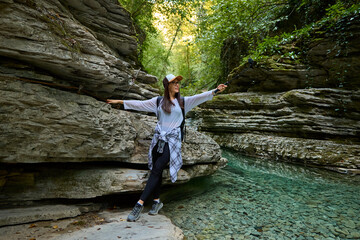 blogger girl travels in a river valley