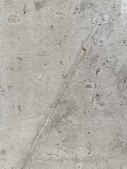Close-up view of a concrete wall texture, showcasing its rough surface and industrial character. Ideal as a background for architecture, construction, or design projects needing a raw and urban.