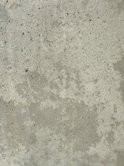 Close-up view of a concrete wall texture, showcasing its rough surface and industrial character. Ideal as a background for architecture, construction, or design projects needing a raw and urban.