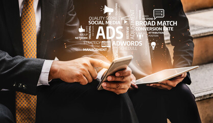 Business professionals collaboratively analyze advertising strategies using mobile devices in a modern office environment, focusing on market trends and digital insights. Tessel