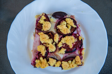 delicious cake with plums on the table