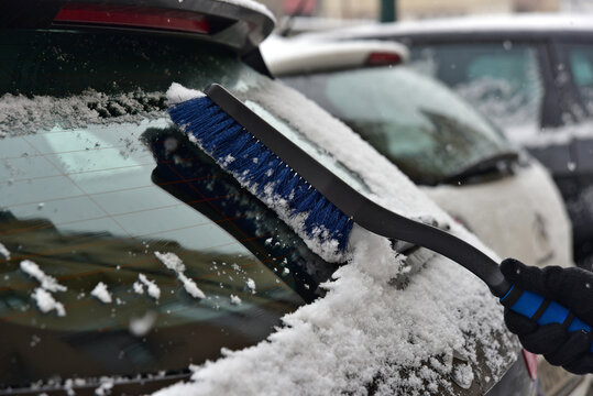 Removing snow from car windshield