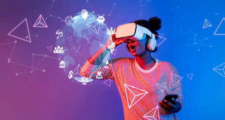 A woman enjoying a virtual reality experience, surrounded by digital graphics and futuristic elements, representing the intersection of technology and creativity in modern lifestyle. XDMCP