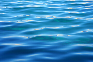 An abstract reflection of blue ocean ripples on the clear water surface
