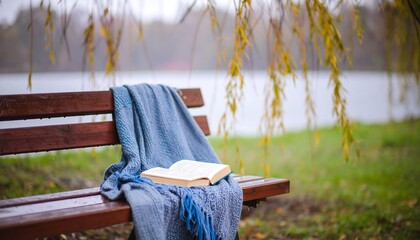 Book on bench in autumn park