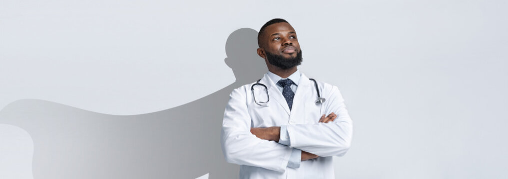 African American doctor stands proudly with arms crossed, portraying confidence and resilience. Symbolizing the heroic nature of healthcare professionals.