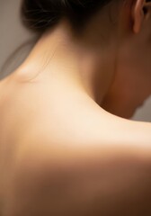 Woman's bare shoulder and neck, healthy skin close up. Focus on relaxation and meditation, self-care concept for spa and wellness.