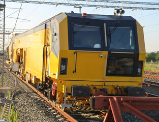 RAILWAY REPAIRS. traction locomotives on serviced at a repair depot. Locomotive on fixed jacking units. new modern yellow railway maintenance locomotive parked at urban train station. Novi Sad. Zgop