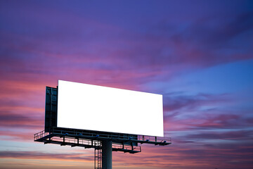 A blank white advertising billboard stands prominently against a beautiful vibrant sunset sky.