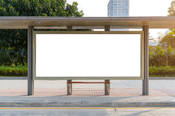 Fototapeta premium An empty white advertisement billboard mockup is prominently featured at a public bus stop, ready for your message in a vibrant urban environment.