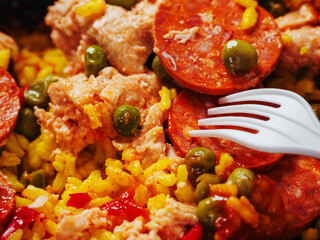 Spanish paella dish with spicy chorizo sausages. Close up. Popular traditional food made of fine rice and other ingredients.