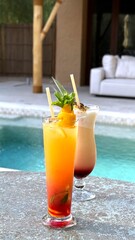 Refreshing cocktails with mint, orange, and pineapple garnishes beside shimmering poolside, capturing tropical relaxation and summer leisure mood