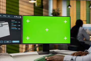 Close up of product designer in office using green screen mockup PC to creating compact solar...