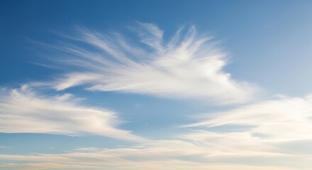 Obraz premium Wispy Cirrus Clouds in a Blue Sky.