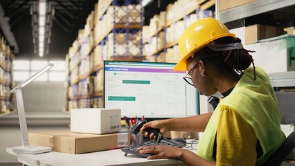 E-commerce worker scanning awb tags on cargo pallets for system registration, using tracking info to update the parcel status on computer software. Express delivery of merchandise. Camera A.