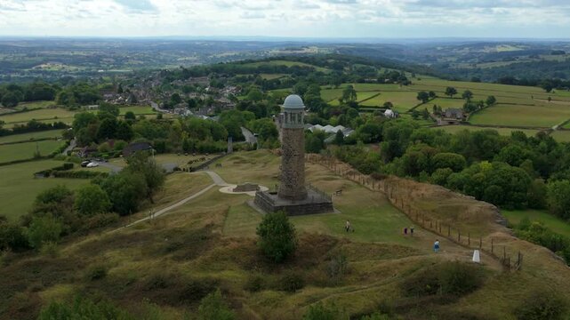 Aerial drone view of Crich Memorial Tower landmark with rolling green valleys and scenic landscapes Derbyshire Dales Ambergate England UK summer