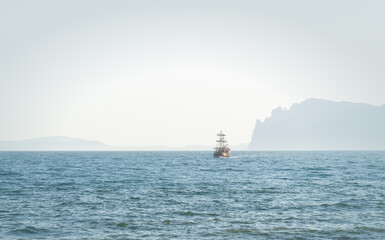 Vintage sailing ship sailing on the sea near the coast