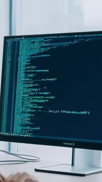 Hands typing code on computer screen displaying complex programming syntax in modern office workspace. concept of software development, coding skills, digital innovation