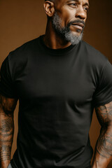 portrait of an older man wearing a black T-shirt - athletic fit and build, gray facial hair- custom screen print blank tee shirt. Graphic design shirt print. Retirement, fashion.