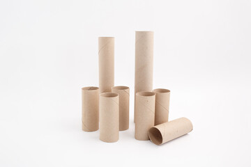 Cardboard tubes standing on white background, ideal for creative DIY projects, recycling campaigns, or craft activities,