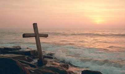 Cross of worn wood facing the horizon where a tranquil ocean meets the dusk with rosy and amber glow while the surf brushes the rocks and the stillness evokes contemplative faith and tender farewell