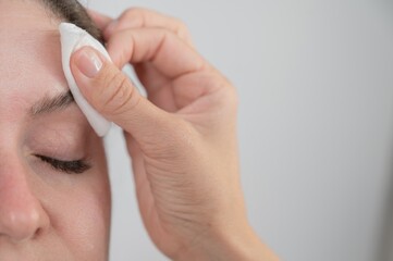 Caucasian woman getting eyebrow tinting procedure. 