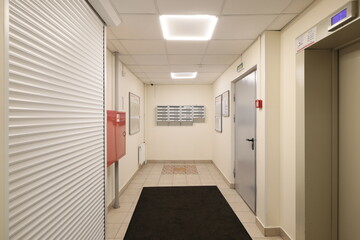 A modern office hallway featuring convenient elevator access for easy navigation and mobility