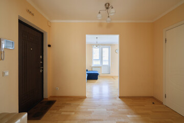 The entrance of a stylish modern interior space is beautifully illuminated with natural light