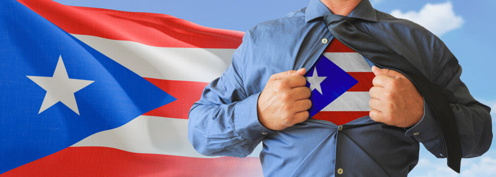 A businessman opening his shirt like super hero with Puerto Rico flag and shows how patriotic he is by revealing his countries flag beneath printed on a t-shirt.