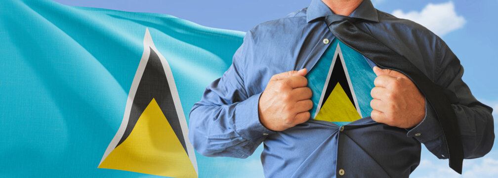 A businessman opening his shirt like super hero with Saint Lucia flag and shows how patriotic he is by revealing his countries flag beneath printed on a t-shirt.