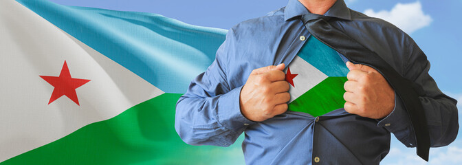 A businessman opening his shirt like super hero with Djibouti flag and shows how patriotic he is by revealing his countries flag beneath printed on a t-shirt.