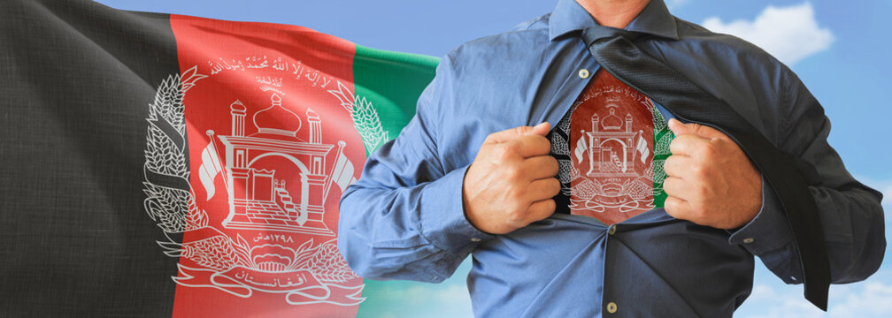A businessman opening his shirt like super hero with Afghanistan flag and shows how patriotic he is by revealing his countries flag beneath printed on a t-shirt.