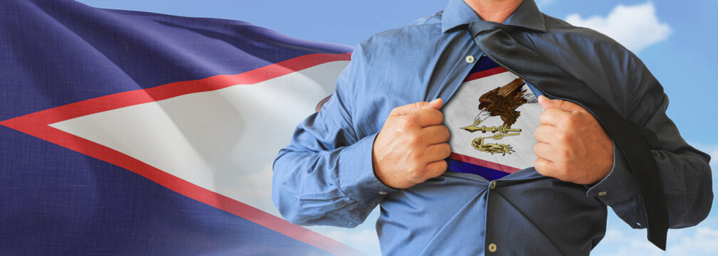 A businessman opening his shirt like super hero with American Samoa flag and shows how patriotic he is by revealing his countries flag beneath printed on a t-shirt.