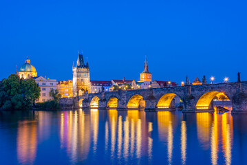 Obraz premium Sunset view of Charles bridge and Saint Salvator church in Pragu