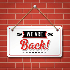 Obraz premium We Are Back Sign on Brick Wall.