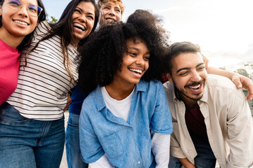 Multicultural happy friends having fun together outdoor in city park - Youth community people enjoying summer moments - Friendship concept with young men and women smiling together