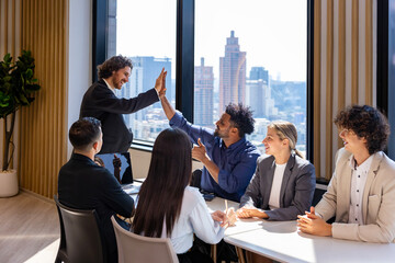 Team of diversity business people having agreement and high five deal on new strategic strategy project on investment real estate with recognition and applause from other colleague for partnership
