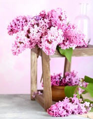 Fototapeta premium Lilac bouquet on wooden stand