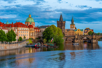Fototapeta premium Sunset view of Charles bridge and Saint Salvator church in Pragu