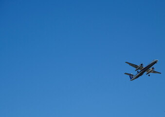 Minimalist Travel Background: A Passenger Plane with Ample Copy Space in the Sky