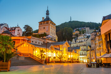 Fototapeta premium Sunset view of palace tower and market colonnade in Karlovy Vary