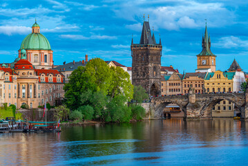 Obraz premium Sunset view of Charles bridge and Saint Salvator church in Pragu