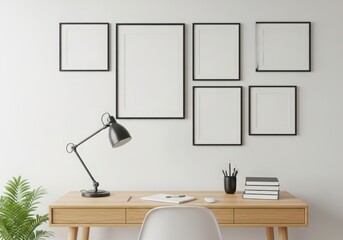 Modern desk setup with blank frames and desk lamp